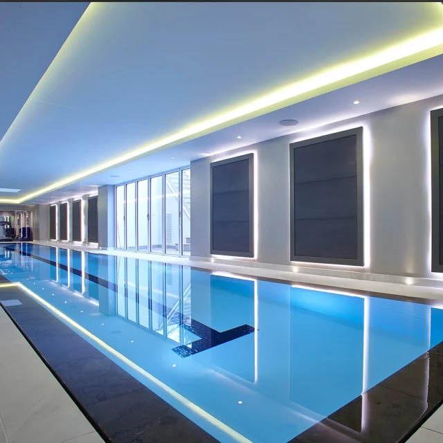 A Striking Deck-Level Swimming Pool in Northwood, London

Guncast has crafted a state-of-the-art indoor lap pool, complete with precise lane markers for a professional swimming experience.

This 25 x 2.8 x 1.2 metre masterpiece features stunning mosaic tiling, seamlessly complemented by LED lighting that enhances the mesmerising pool overflow effect.

The pool hall is expertly designed to brilliantly showcase the car enthusiast garage, creating the ultimate leisure experience for all.

The perfect combination of functionality and design – this pool truly redefines bespoke luxury.

#London #LuxurySwimmingPool #LapPool #Guncast